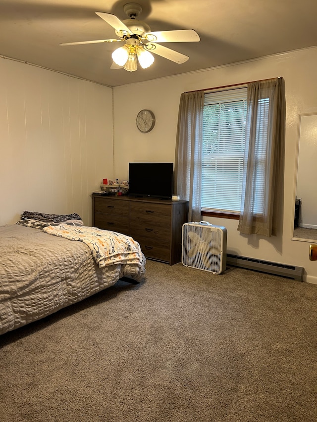 carpeted bedroom with ceiling fan and a baseboard heating unit