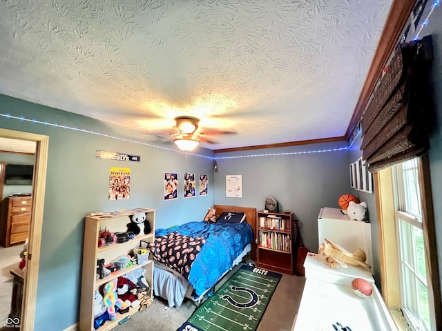 bedroom with ceiling fan and a textured ceiling