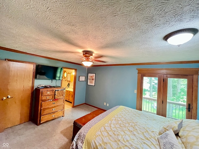 carpeted bedroom featuring access to exterior, a textured ceiling, and ensuite bath