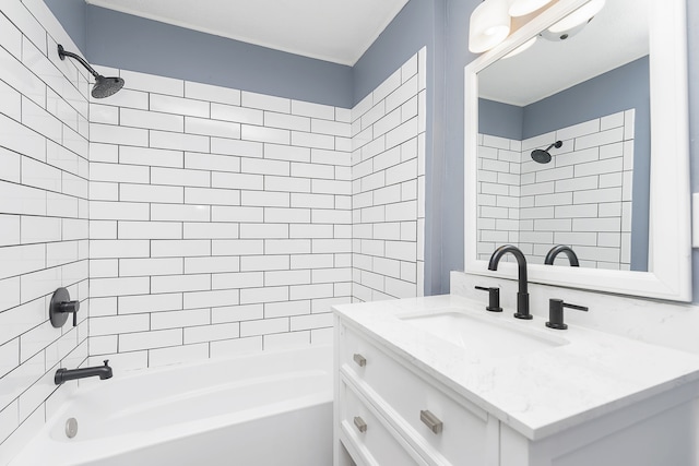 bathroom with tiled shower / bath combo and vanity