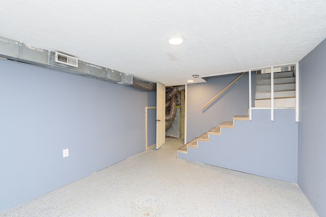 basement featuring a textured ceiling