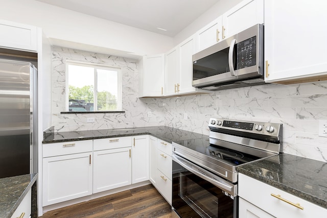 kitchen with dark hardwood / wood-style flooring, stainless steel appliances, backsplash, and white cabinetry