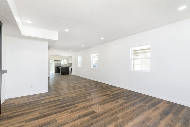 unfurnished living room featuring dark hardwood / wood-style flooring