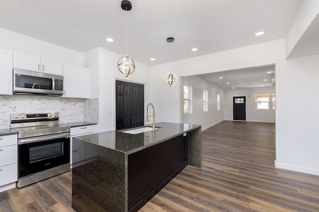 kitchen featuring dark hardwood / wood-style flooring, white cabinets, stainless steel appliances, and sink