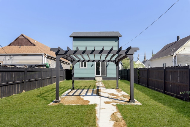 back of house featuring a lawn and a pergola