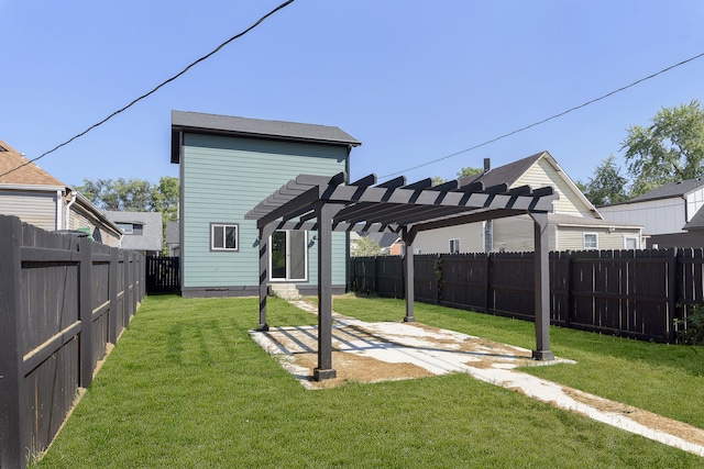 rear view of house with a pergola, a patio area, and a yard