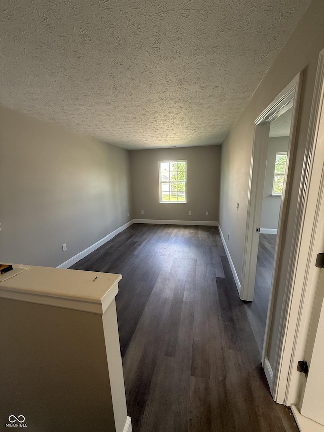 17902 Cristin Way, Westfield, IN 46062 - unfurnished room with dark wood-style floors and a textured ceiling