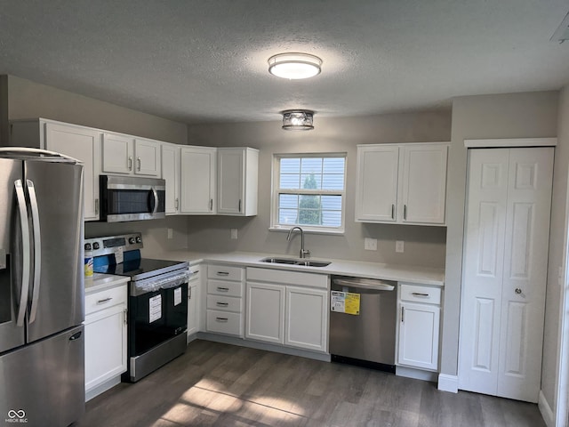 17902 Cristin Way, Westfield, IN 46062 - kitchen with appliances with stainless steel finishes, dark wood finished floors, white cabinetry, light countertops, and a textured ceiling