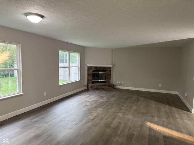17902 Cristin Way, Westfield, IN 46062 - unfurnished living room with a textured ceiling, dark wood-style floors, and a fireplace