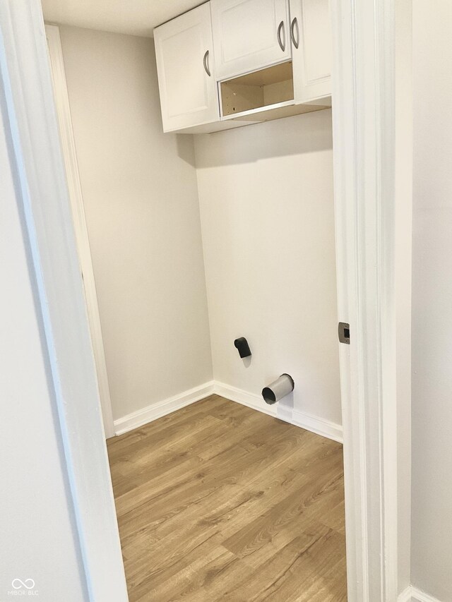 1327 Blue Ridge Ln, Brownsburg, IN 46112 - washroom featuring cabinet space, light wood-style flooring, and baseboards