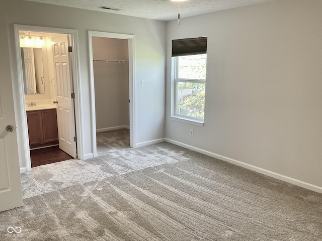 1327 Blue Ridge Ln, Brownsburg, IN 46112 - unfurnished bedroom with carpet, a spacious closet, a sink, baseboards, and a closet