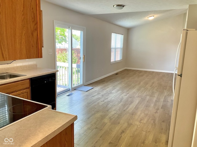 1327 Blue Ridge Ln, Brownsburg, IN 46112 - kitchen with dishwasher, freestanding refrigerator, light wood-style floors, baseboards, and brown cabinets
