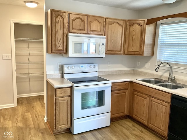 1327 Blue Ridge Ln, Brownsburg, IN 46112 - kitchen with white appliances, a sink, light wood finished floors, and light countertops
