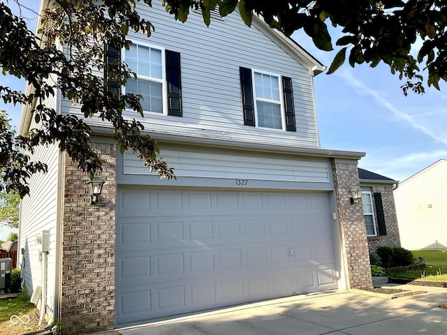 1327 Blue Ridge Ln, Brownsburg, IN 46112 - view of side of home with an attached garage, brick siding, driveway, and cooling unit