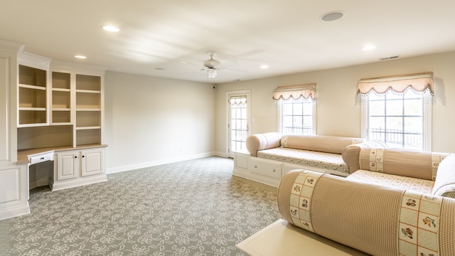 carpeted living room featuring ceiling fan