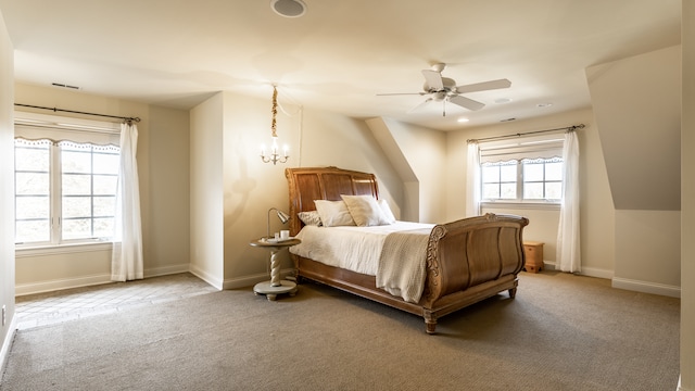 bedroom with ceiling fan with notable chandelier and carpet floors