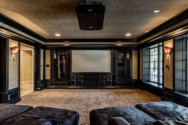 carpeted home theater room featuring crown molding