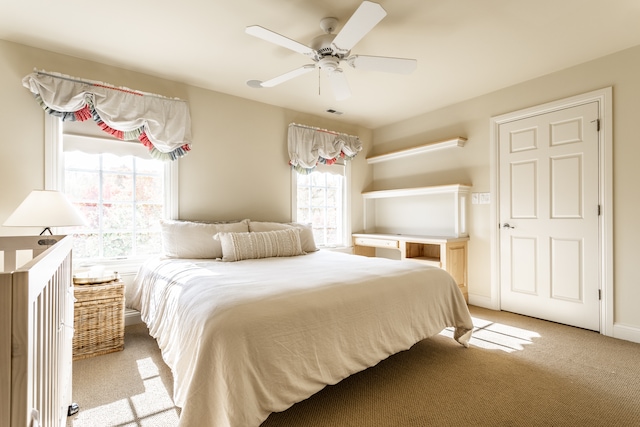 bedroom featuring light carpet and ceiling fan