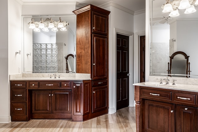 bathroom featuring vanity, hardwood / wood-style flooring, ceiling fan, and ornamental molding