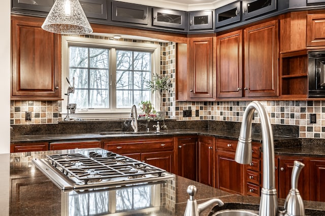 kitchen with black microwave, sink, and dark stone counters