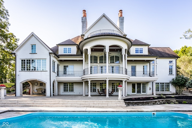 back of property featuring a patio and a balcony