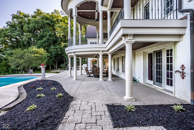 view of patio / terrace with ceiling fan and a balcony