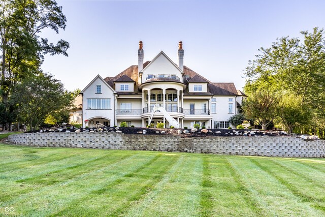 rear view of house featuring a lawn