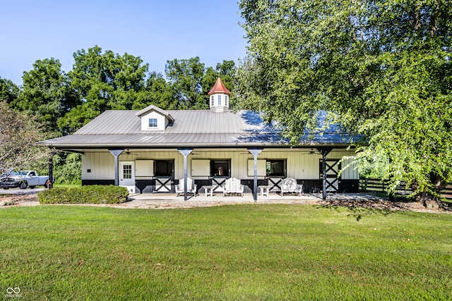 back of house with covered porch, a yard, and ceiling fan