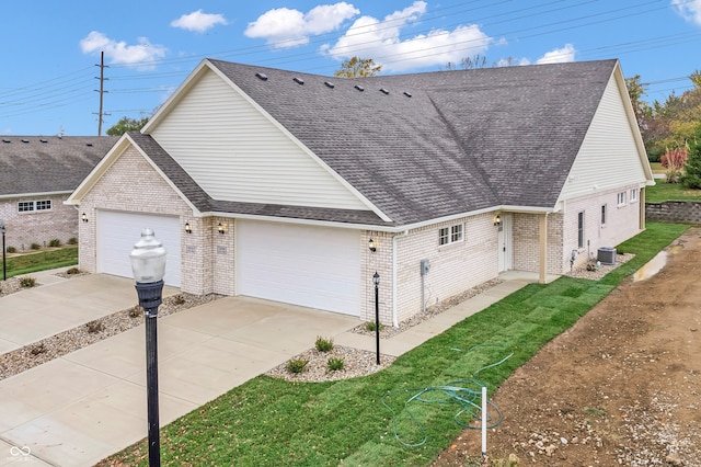 view of home's exterior with central AC unit, a garage, and a yard