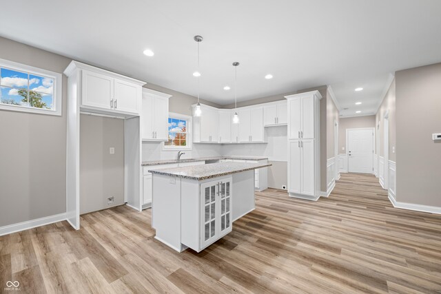 3368 Johns Way, Greenwood, IN 46143 - kitchen with light wood finished floors, a kitchen island, white cabinetry, light stone counters, and recessed lighting