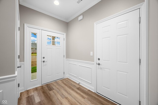 3368 Johns Way, Greenwood, IN 46143 - entryway with ornamental molding, light wood-style floors, a wainscoted wall, and a decorative wall