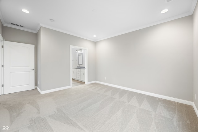 empty room with light colored carpet and crown molding