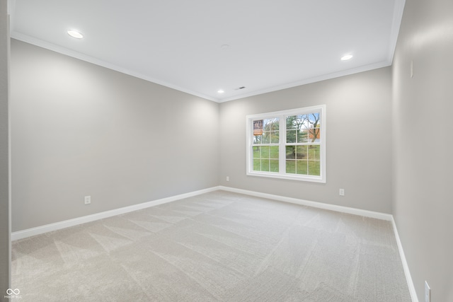 carpeted spare room featuring ornamental molding