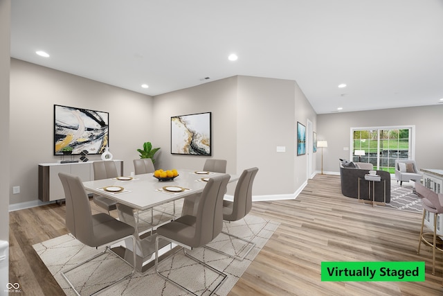 dining space with light hardwood / wood-style flooring