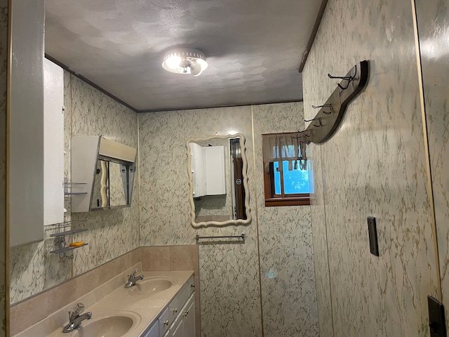 bathroom with crown molding and vanity