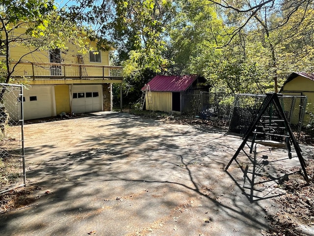 view of patio with a storage unit and a garage