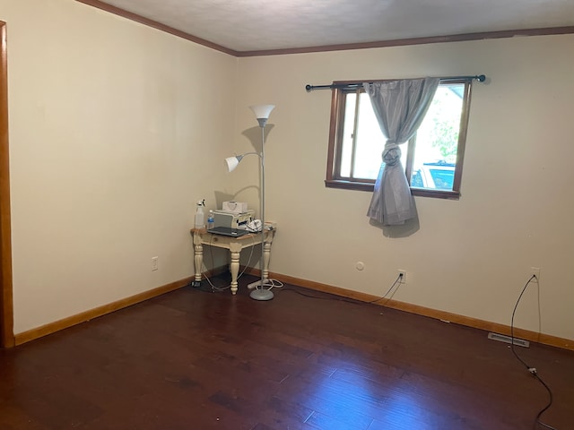 unfurnished room featuring ornamental molding and dark hardwood / wood-style floors