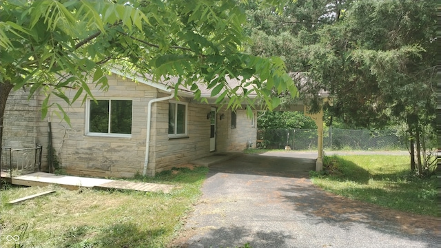 view of property exterior with a yard