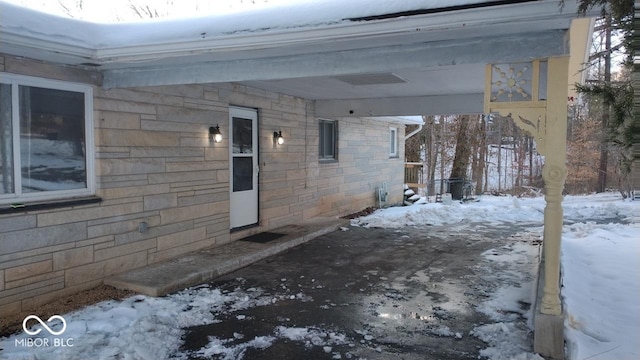 view of snow covered property entrance