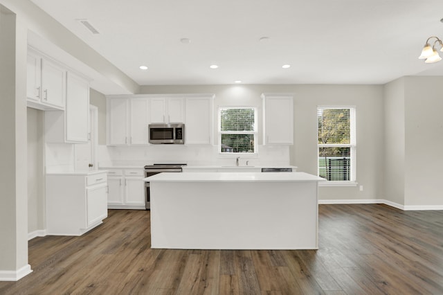 kitchen with white cabinetry, dark wood-type flooring, and stainless steel appliances