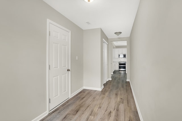 hall with light hardwood / wood-style flooring