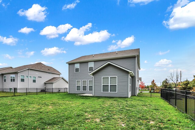 rear view of property featuring a yard