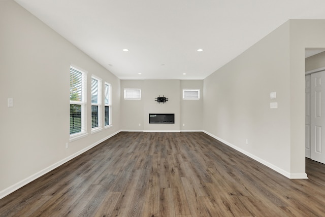 unfurnished living room with dark hardwood / wood-style flooring