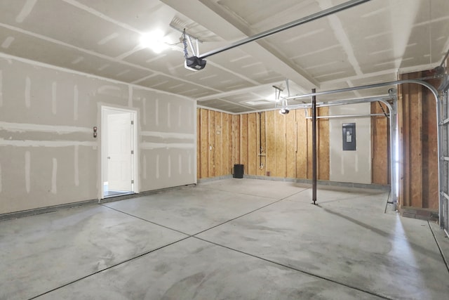 garage with wooden walls and a garage door opener