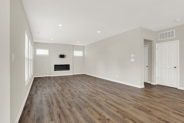 unfurnished living room featuring dark hardwood / wood-style floors