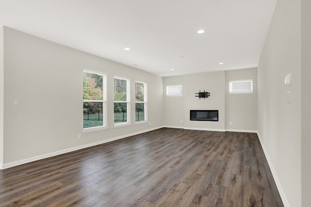 unfurnished living room featuring dark hardwood / wood-style flooring