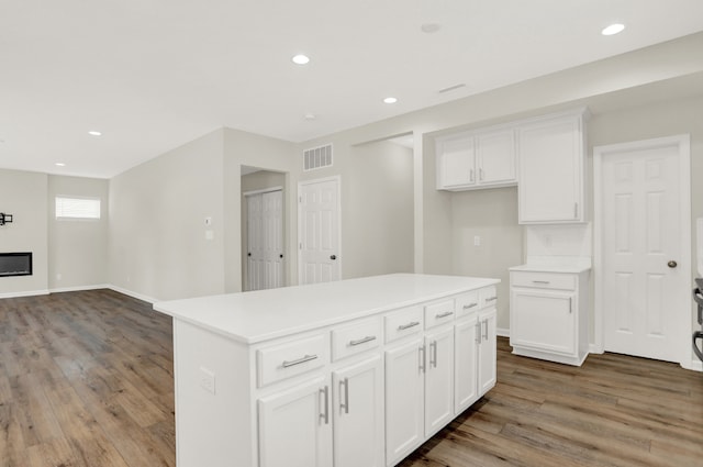 kitchen featuring a center island, hardwood / wood-style flooring, and white cabinetry