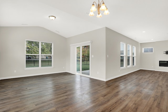 unfurnished room with a notable chandelier, lofted ceiling, and dark hardwood / wood-style floors