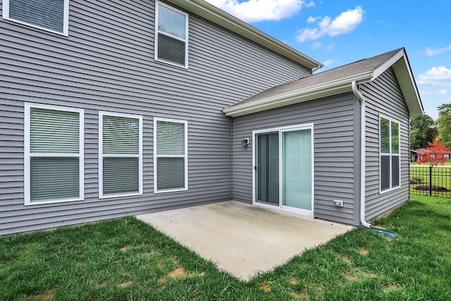 rear view of property featuring a patio and a yard