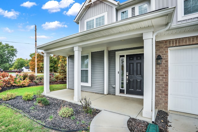 view of exterior entry featuring covered porch